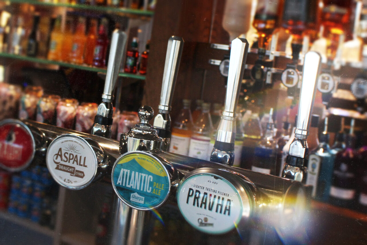 Close up photograph of cold beer taps with condensation